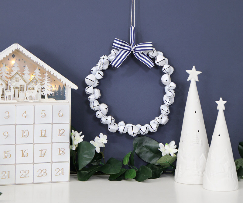 White Jingle Bell Wreath with Blue Bow